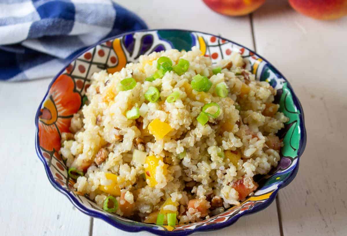 A colorful bowl filled with a quinoa and rice salad. 