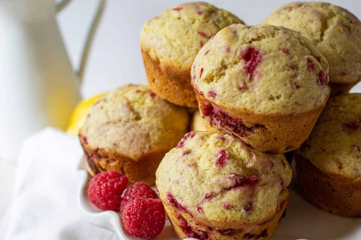 A stack of muffins filled with raspberries. 