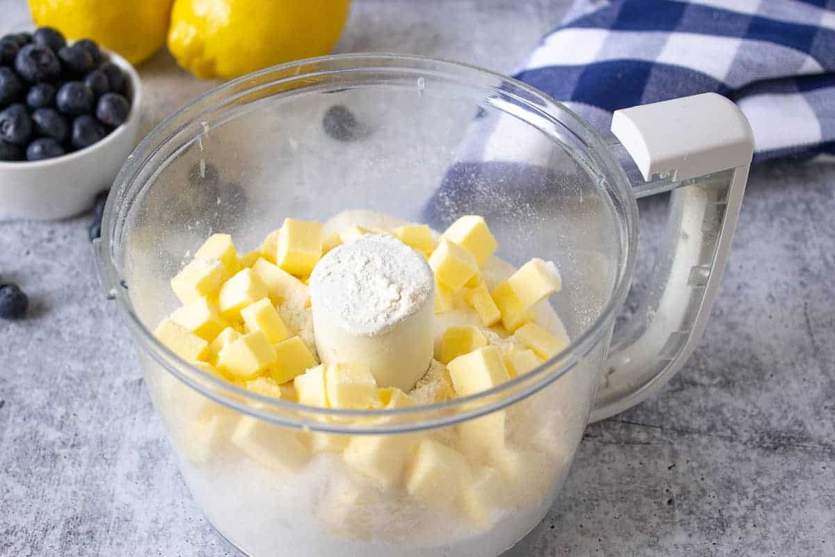 Butter and flour in the bowl of a food processor.