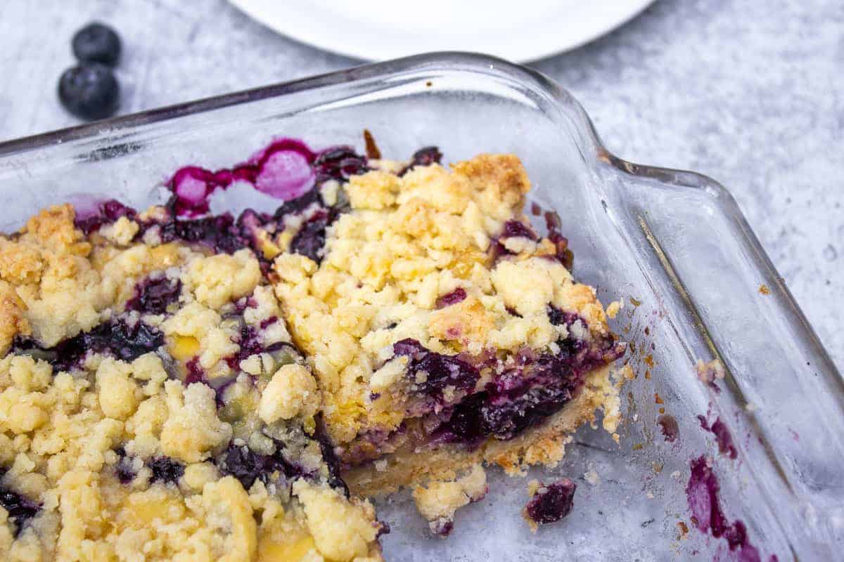 A glass dish filled with blueberry bars.