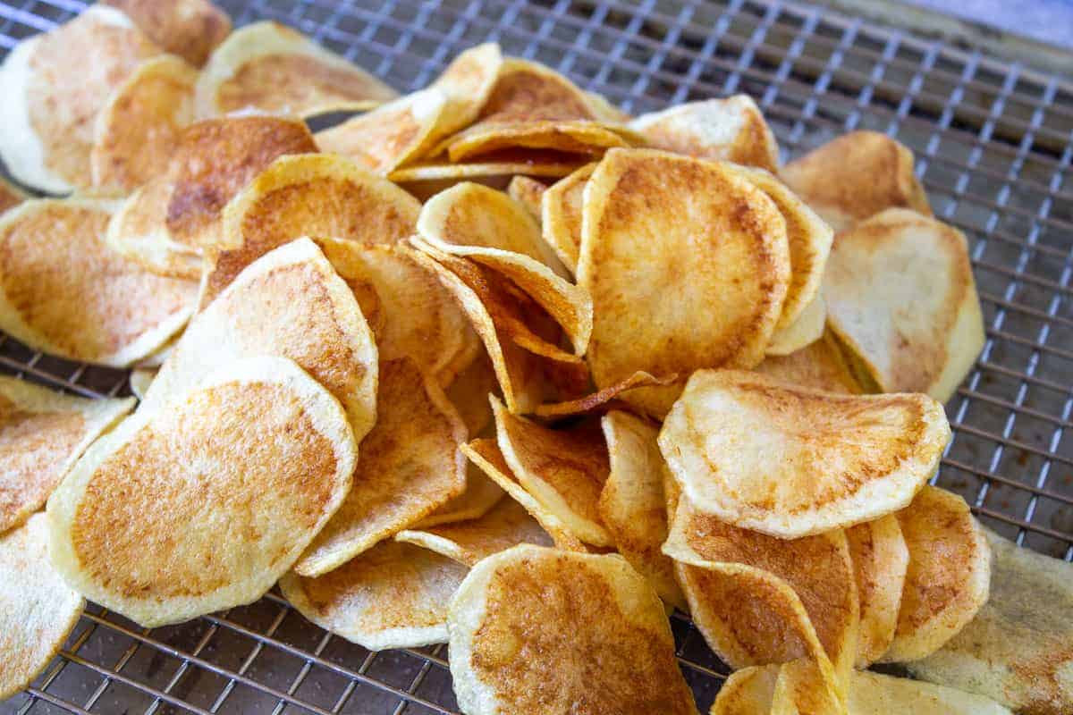 Thick cut potato chips on a baking rack.