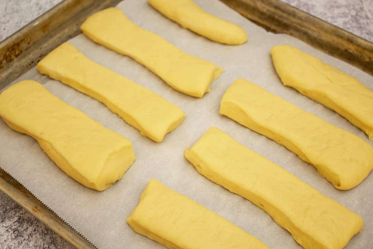 Maple bar dough on a baking sheet lined with parchment paper.