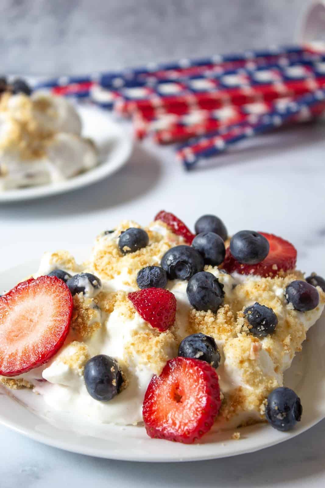 Strawberries and blueberries with whipped cream and a cookie crumble.