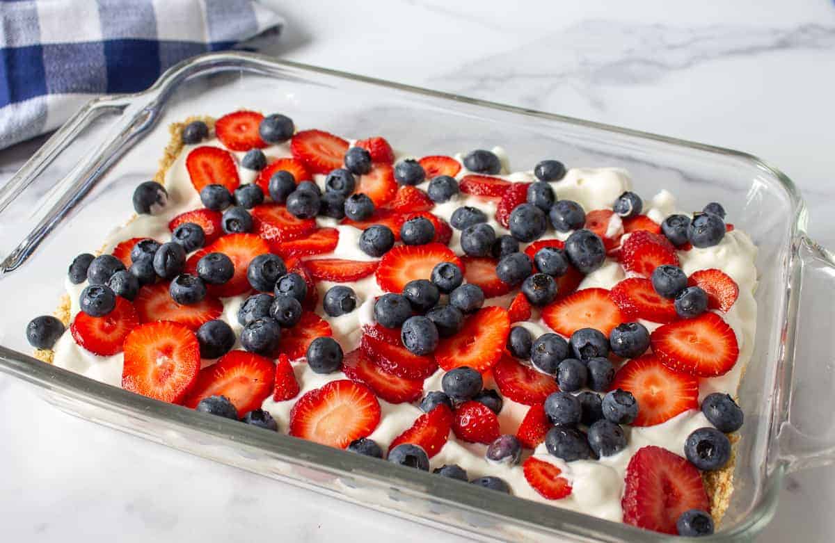 Blueberries and strawberries in a glass casserole dish.