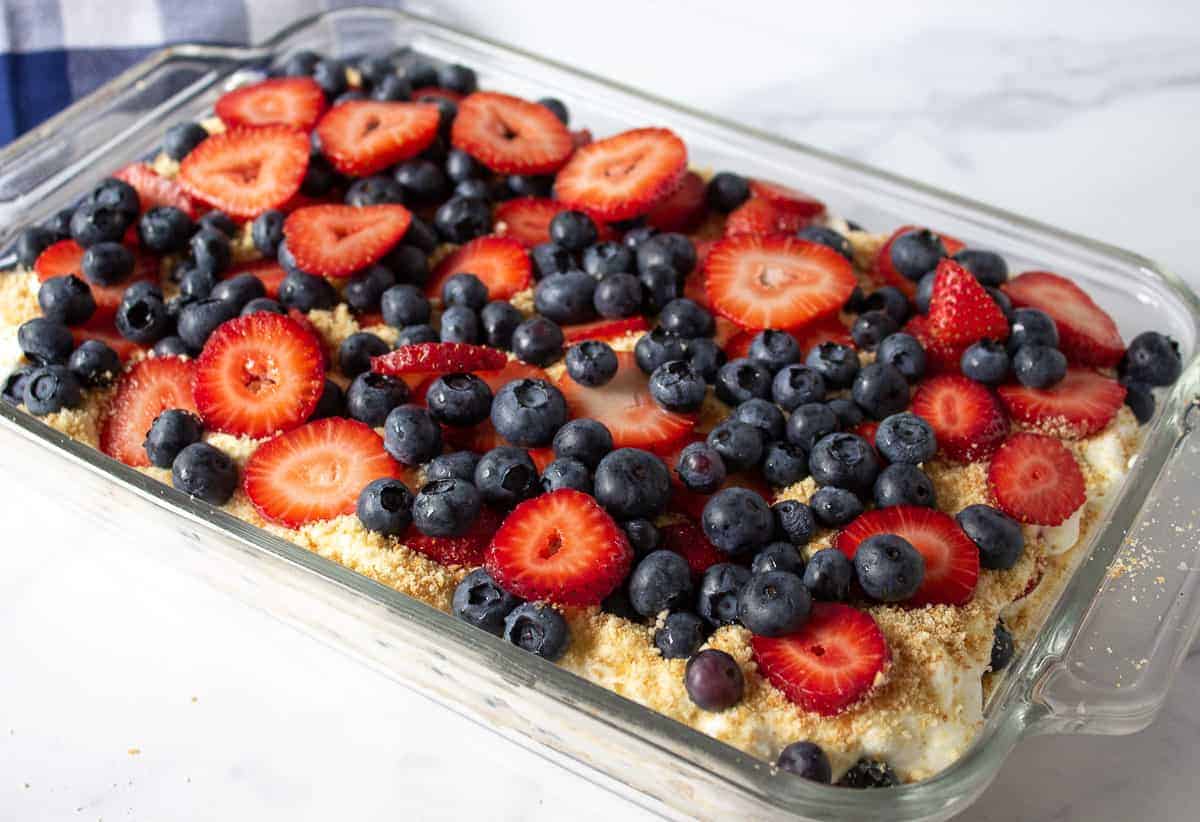 Blueberry and strawberry dessert in a glass baking dish.