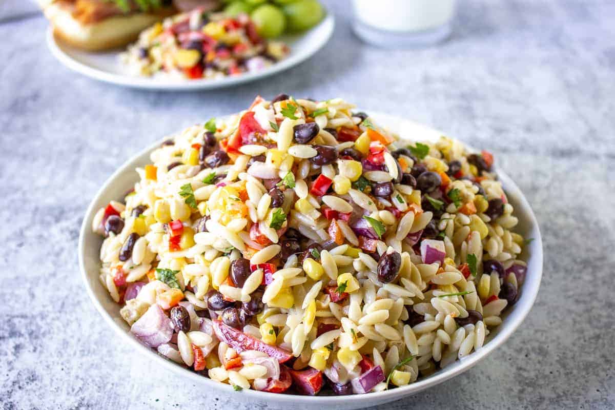 Orzo pasta salad in a large white bowl.