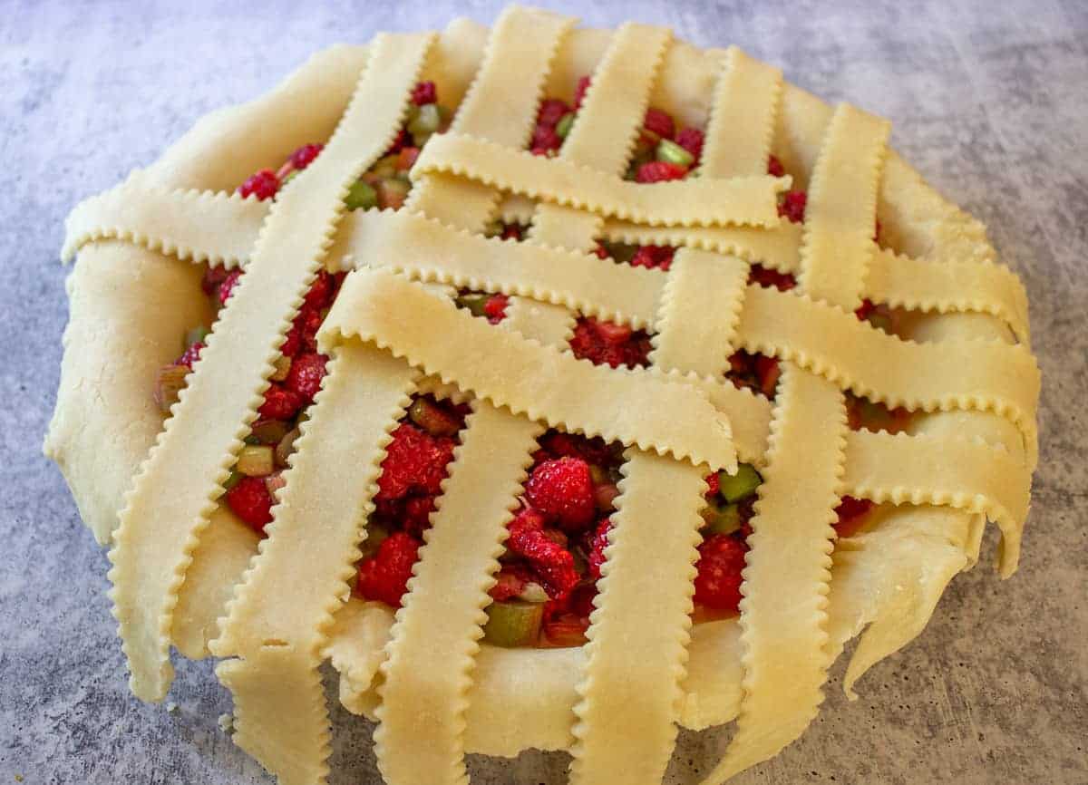 Building the top crust with lattice strips.