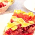 Rhubarb raspberry pie slice on a plate.