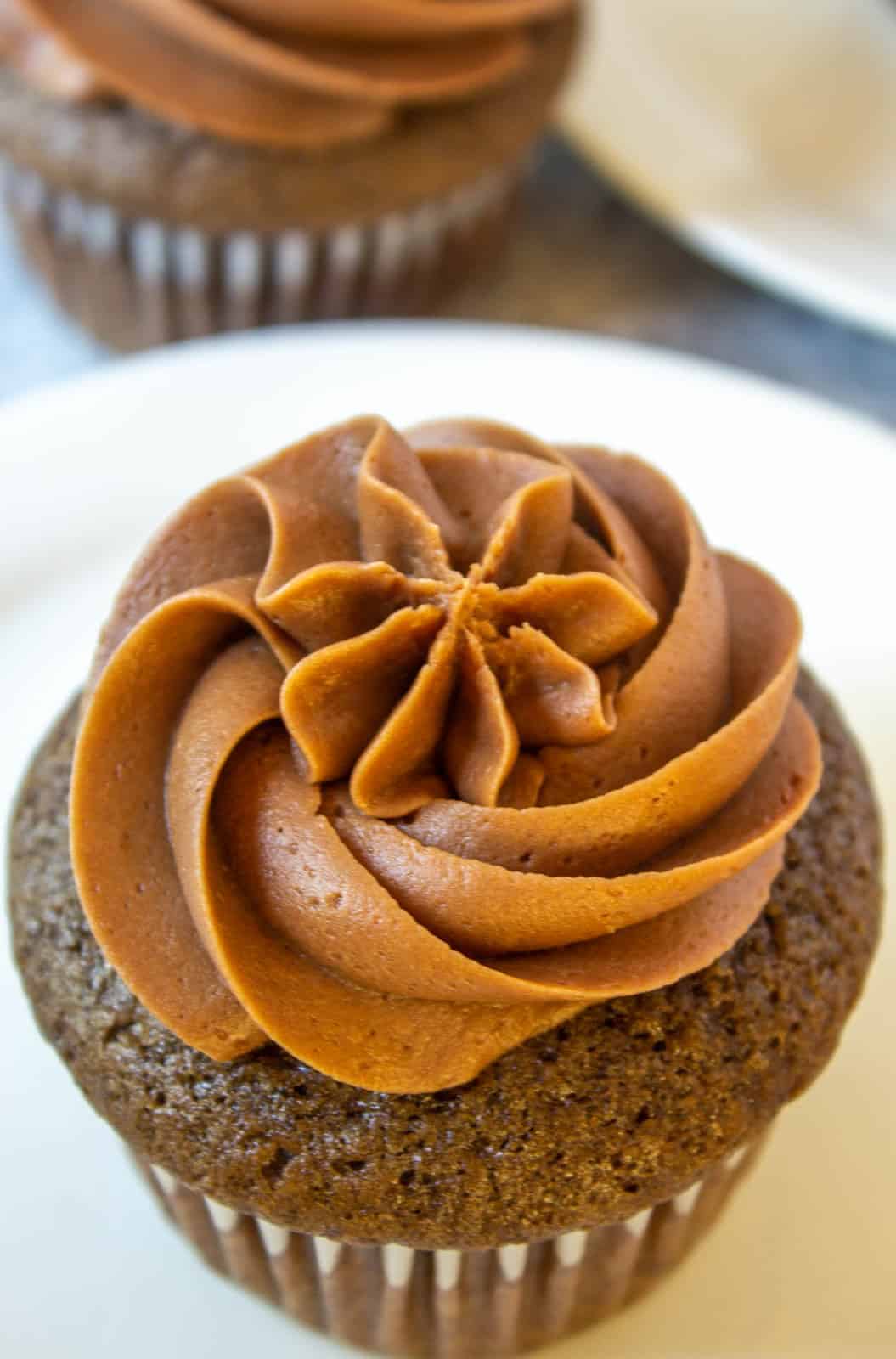 A chocolate cupcake topped with chocolate swirled frosting. 