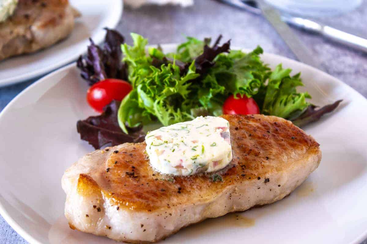 Compound butter on a cooked pork chop.