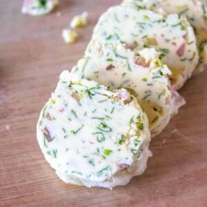 Slices of compound butter with shallots, cilantro and lime.