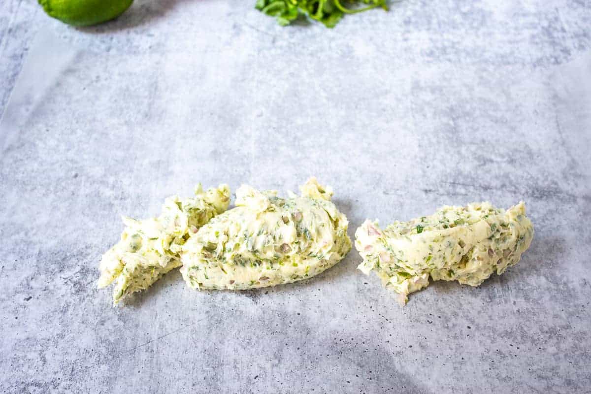 Butter with herbs on a piece of waxed paper.