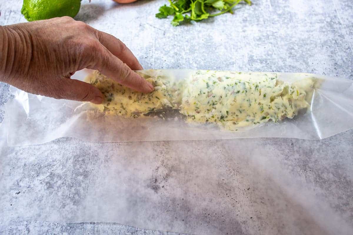 Forming butter into a long log.