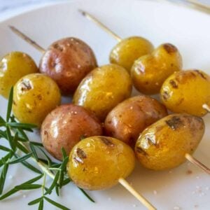 Grilled baby potatoes skewered on a stick.