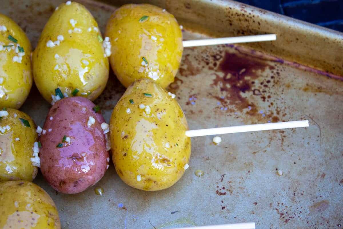 Baby potatoes on a wooden skewer.