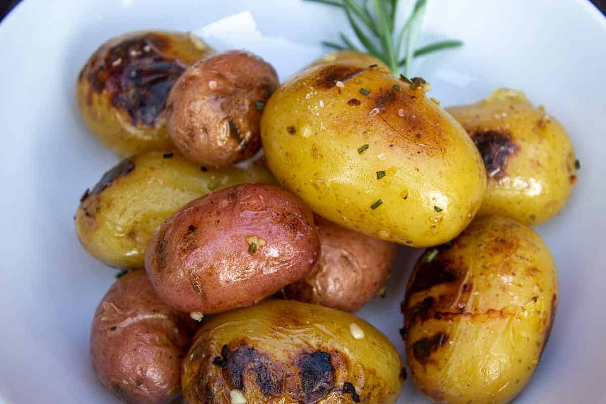 Grilled baby potatoes with a sprig of rosemary.