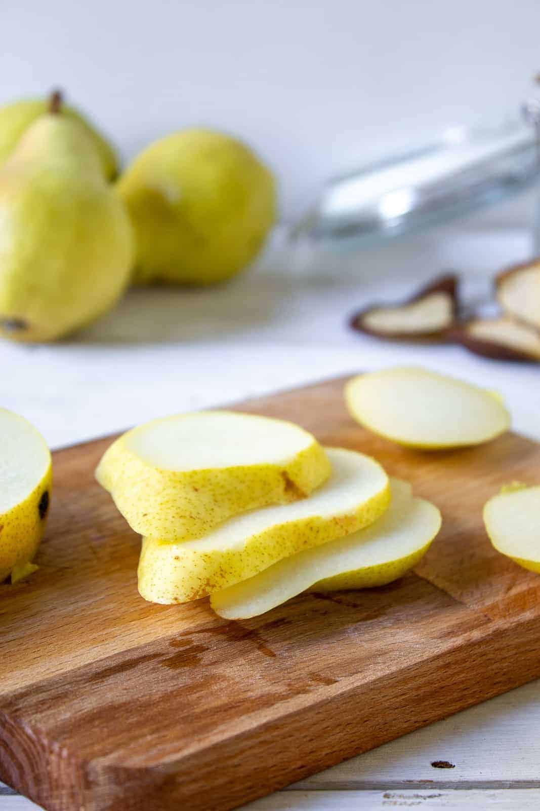 Slices of fresh pear on a cutting board.