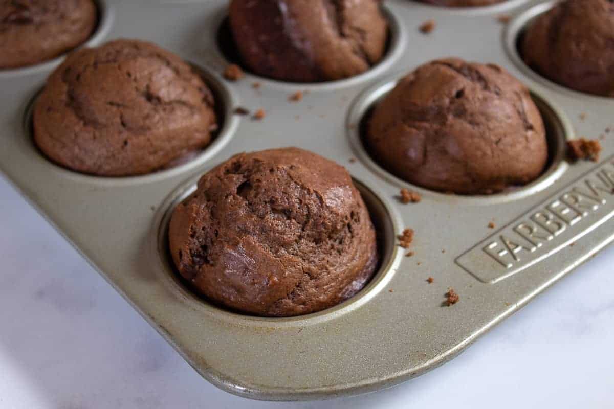 Chocolate muffins in a muffin tin.