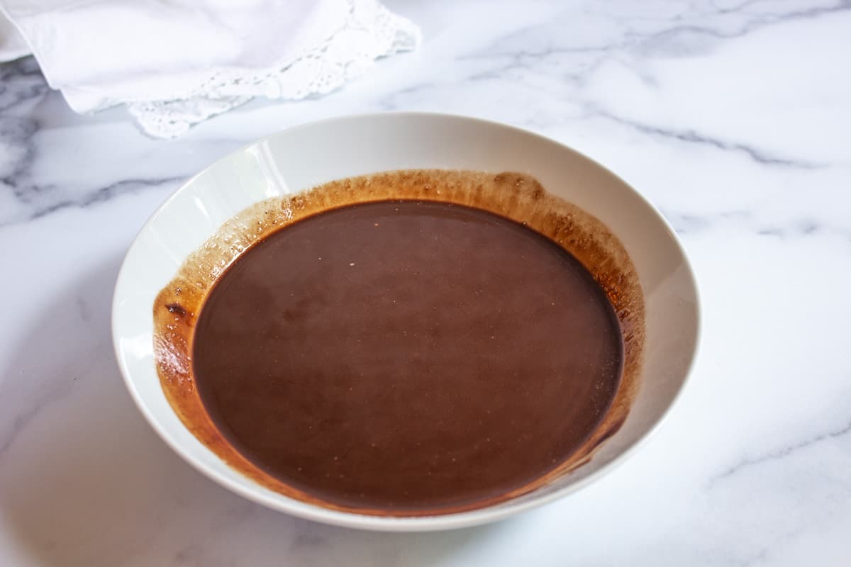 Melted chocolate in a white bowl.