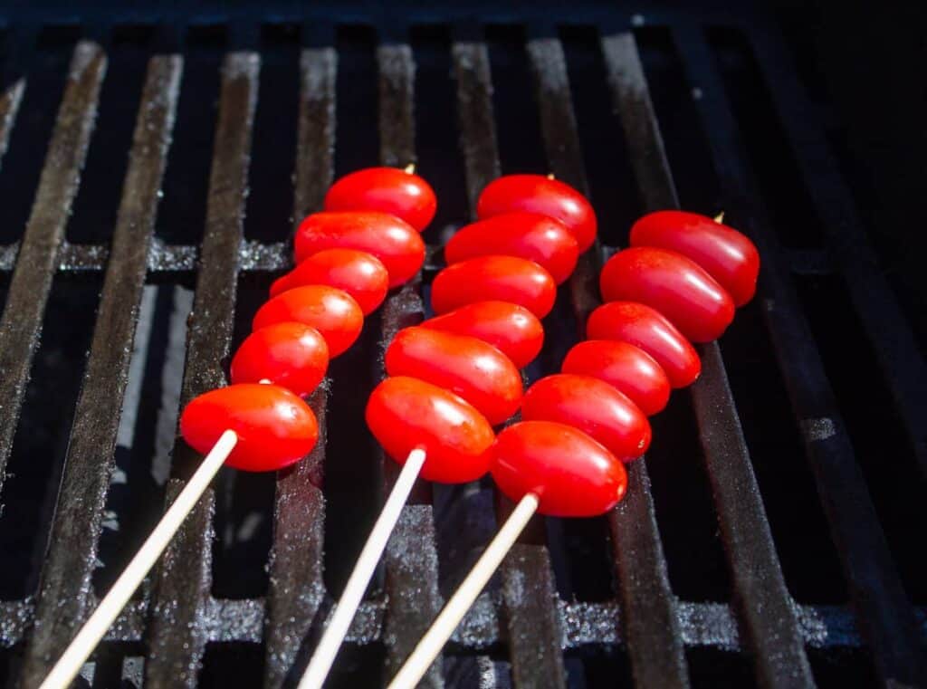 Tomato skewers on a barbecue grill.