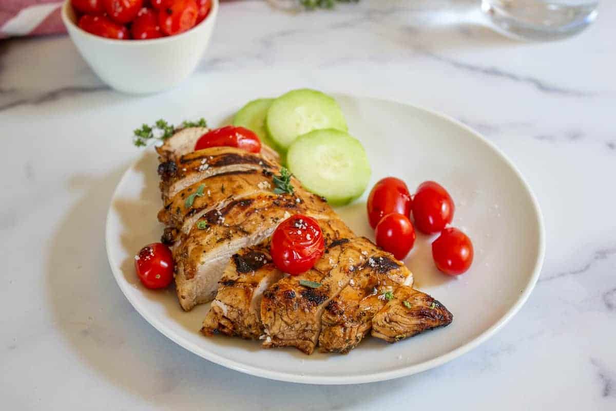 Grilled chicken breast topped with grilled cherry tomatoes.