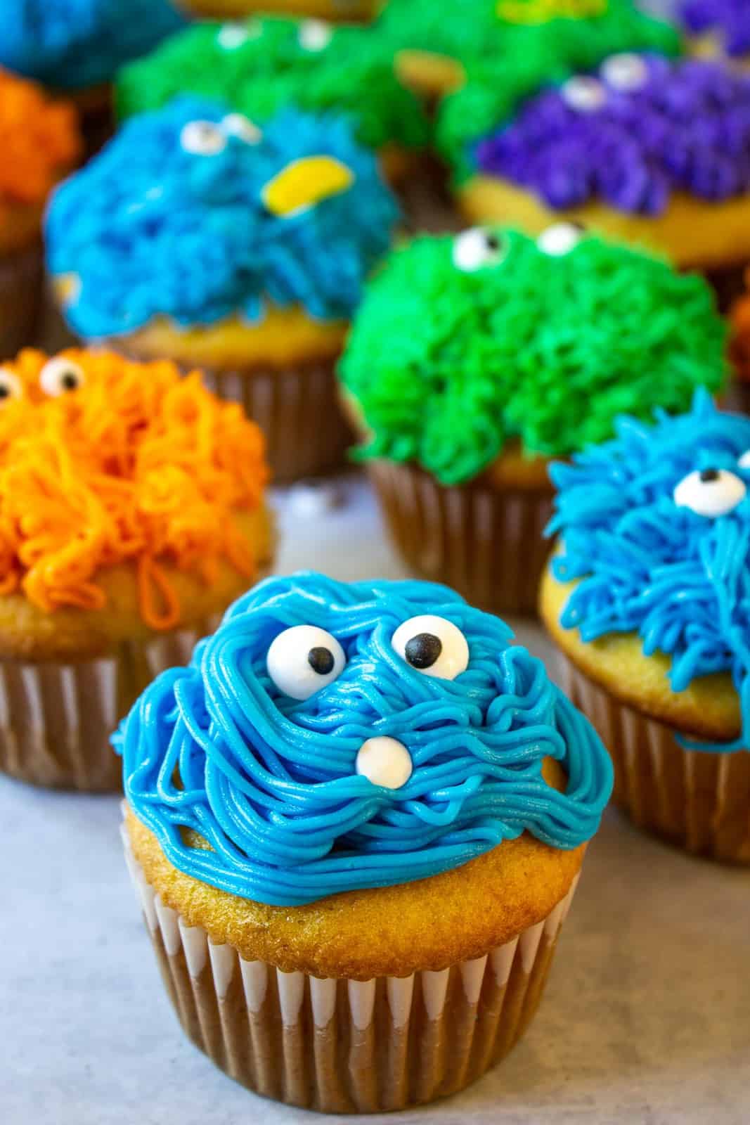 Blue, Orange and green monster cupcakes. 