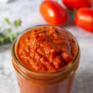 A jar filled with oven roasted tomato sauce.