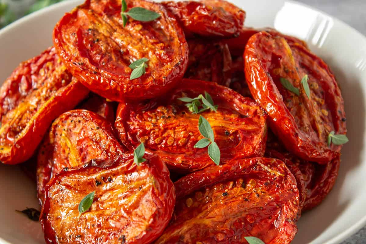 A bowl filled with oven roasted tomatoes.