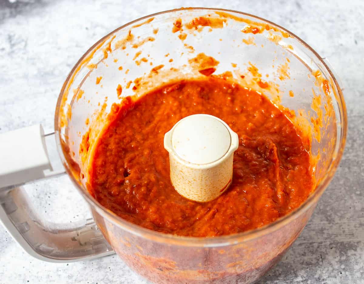 Pureed tomato sauce in a food processor bowl.