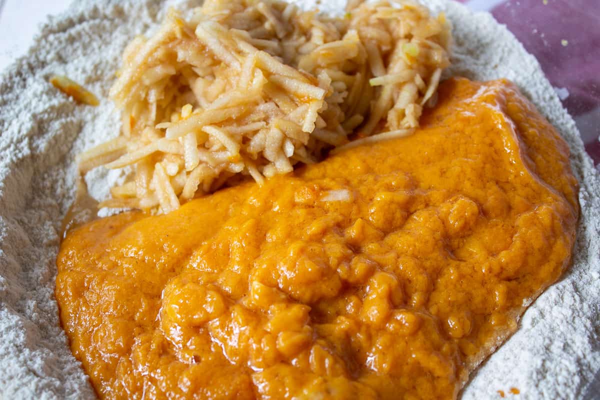 Pumpkin puree with grated apples in a bowl.