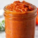 A quart glass jar filled with roasted tomato sauce.