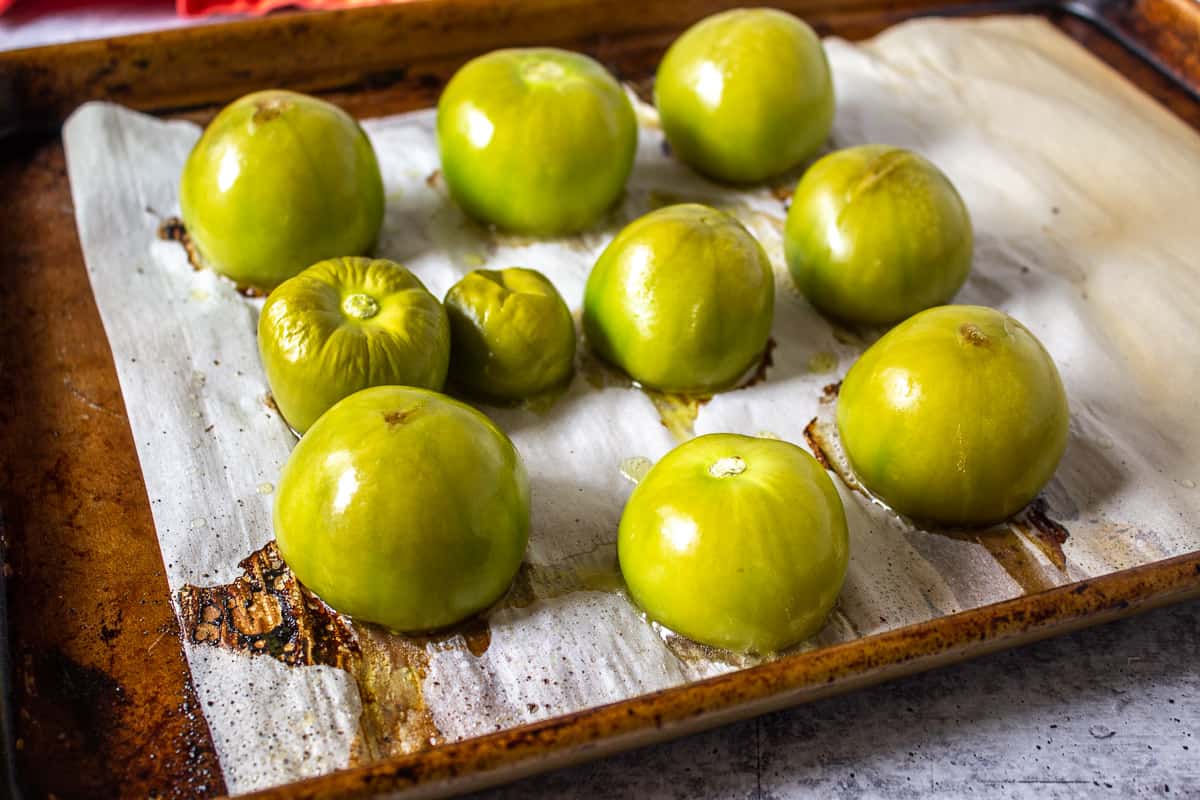 Roasted tomatillos on a baking sheet.