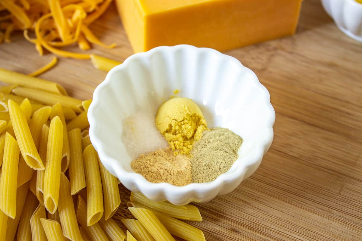 A small white bowl filled with dry mustard and other seasonings.