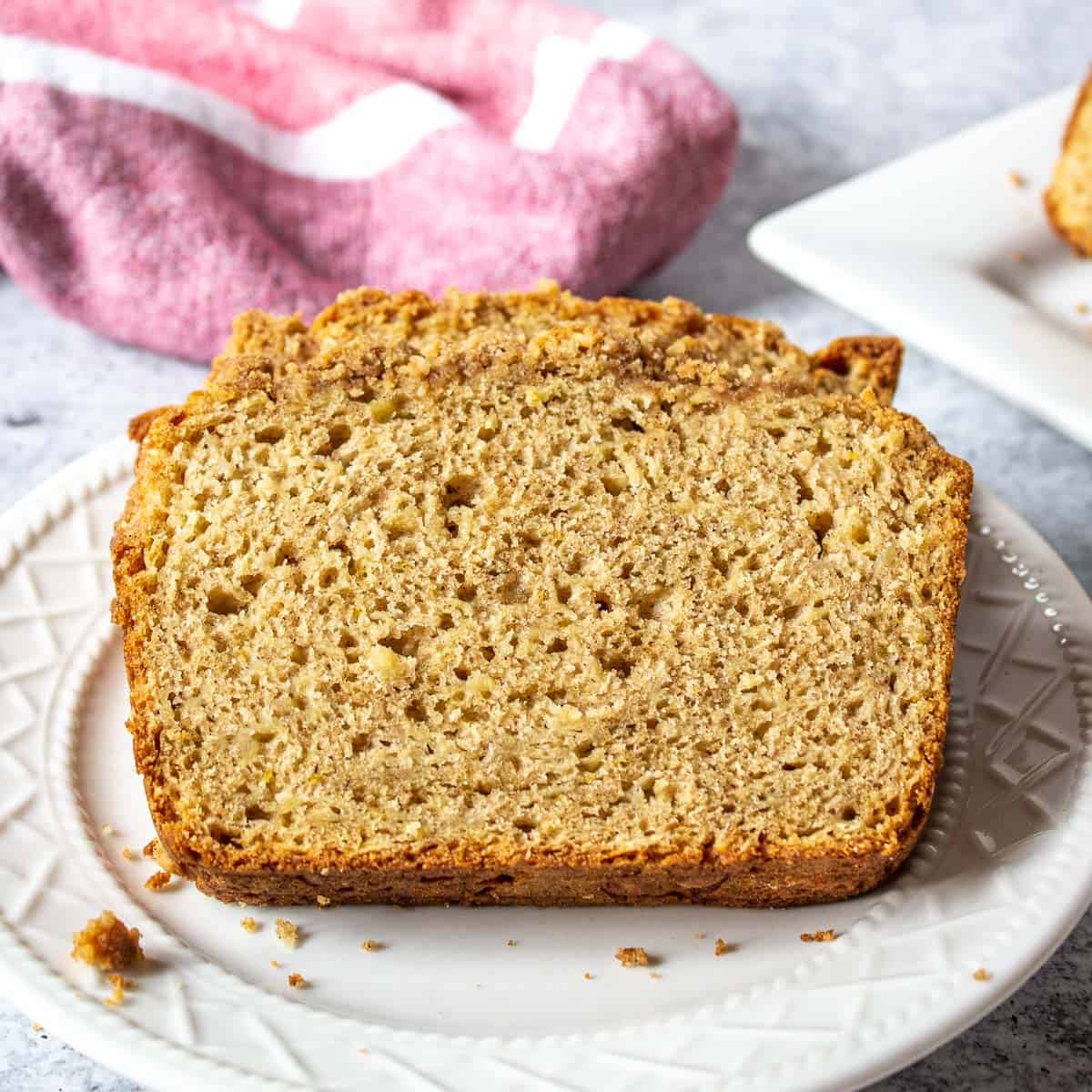 Slices of apple bread of a white plate.