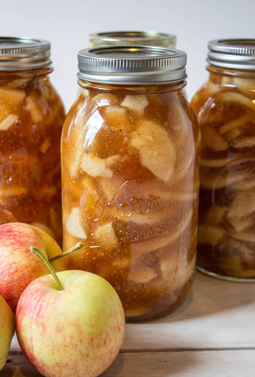 Glass canning jars filled with an apple filling.