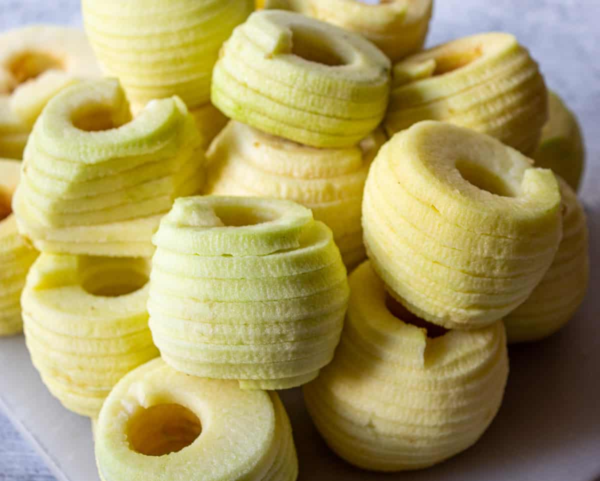 A pile of peeled and cored apples. 