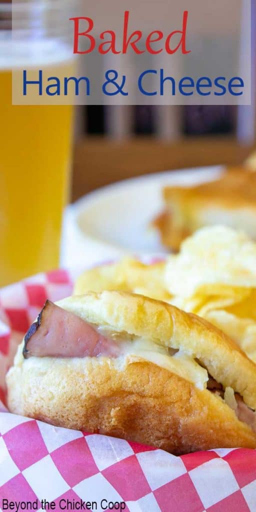 A sandwich in a basket with potato chips.