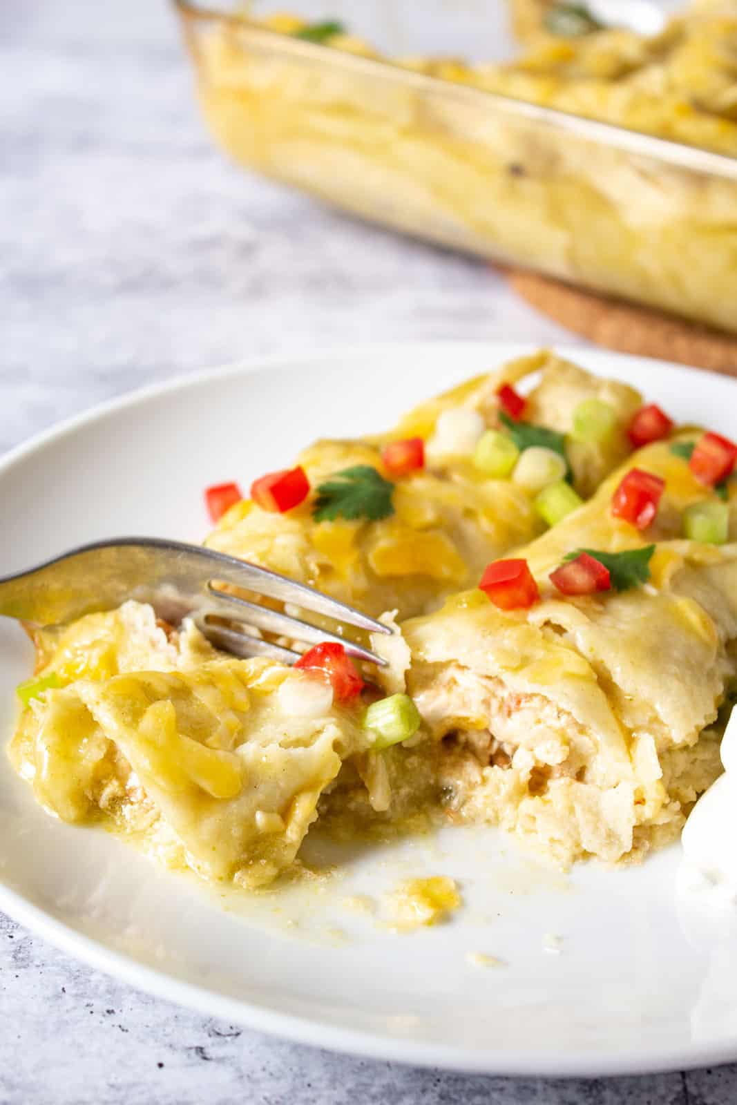 Enchiladas cut with a fork on a plate. 