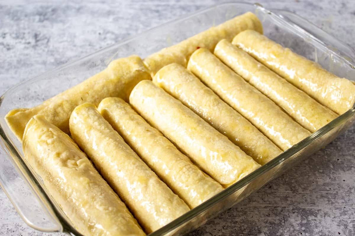 Enchiladas in a glass baking dish.