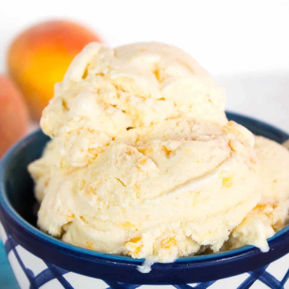 A blue and white bowl filled with peach ice cream.