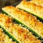 Golden brown topping on long halves of zucchini.