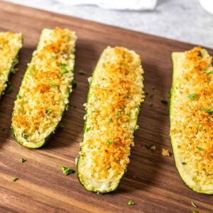 Roasted zucchini with browned parmesan cheese and bread crumbs on top.