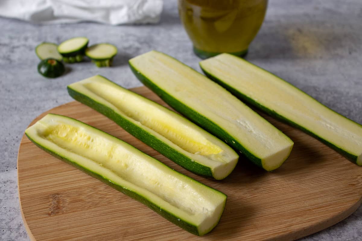 Zucchinis halved with the seeds scooped out.  