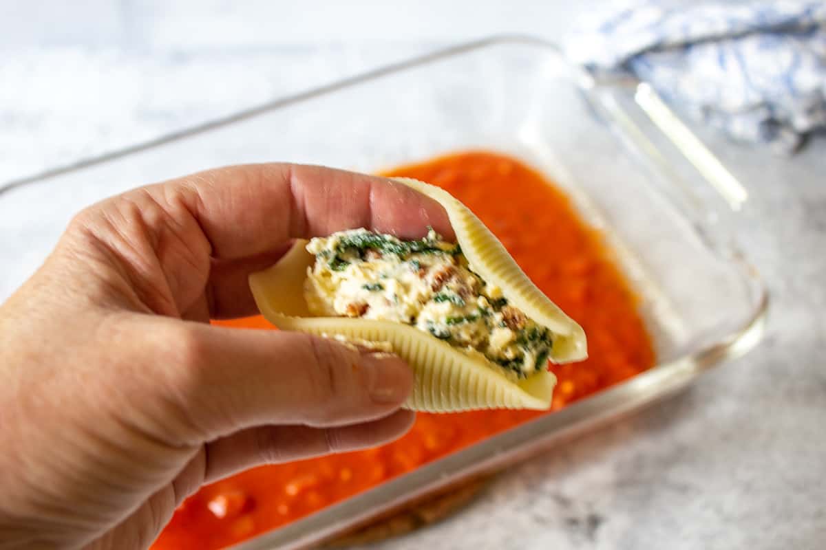 Cheese filling inside a pasta shell.