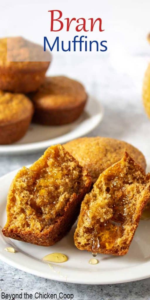 Bran muffins on a white plate with one muffin split in half and covered with honey.