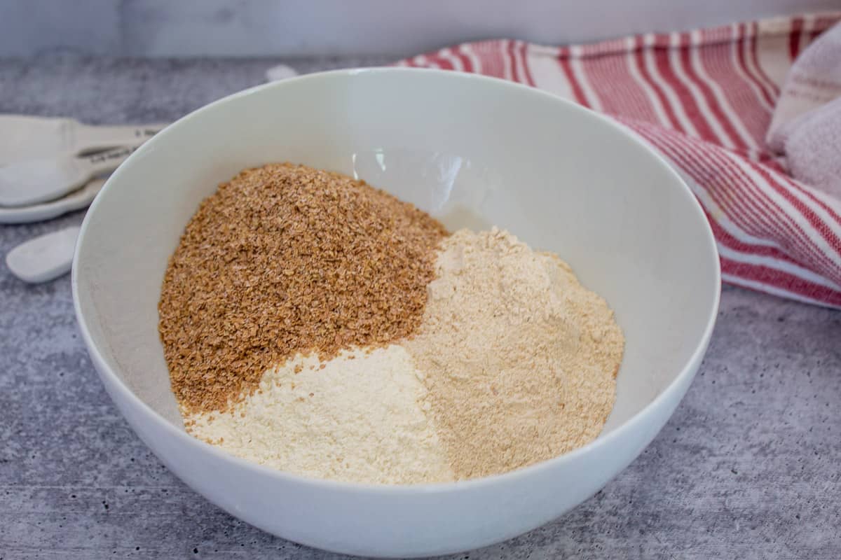 Three types of flour in a white bowl.