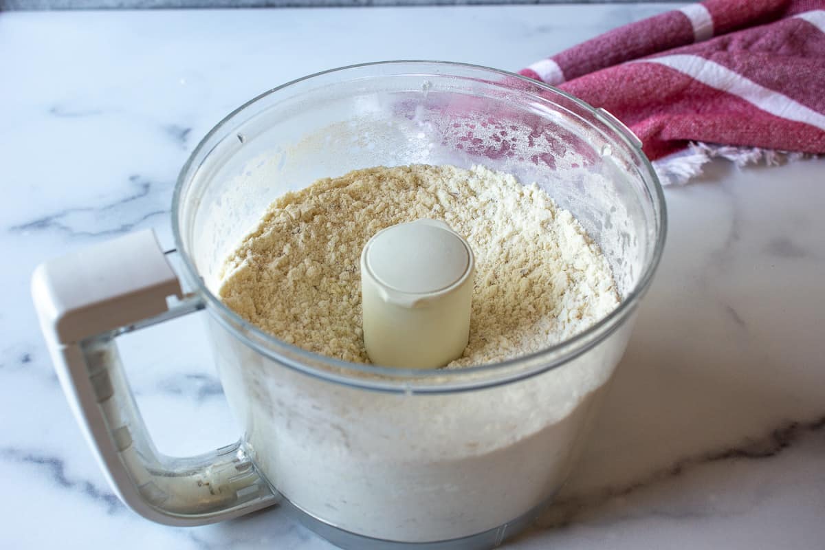 A flour mixture in a food processor bowl.