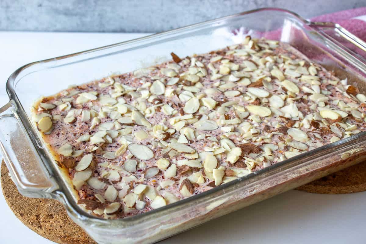 An unbaked dessert with cranberries and almonds.