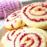 A plate of cranberry orange cookies on a white plate.