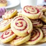 Cranberry pinwheel cookies piled on a plate.
